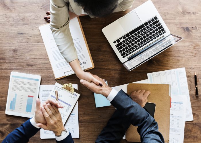business-people-shaking-hands-together (1)